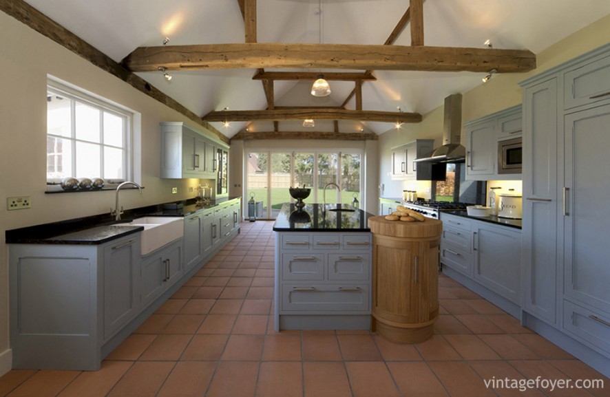 This industrialist kitchen is perfect for those who value simplicity. The red, subway tiled floor is provided the perfect contrast to the machinist-blue cabinets, combined with lots of natural light and plenty of counter space.