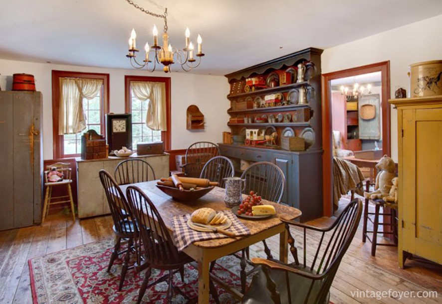 This kitchen adds a pop of color with red window frames, red carpet, and red accents. Combined with a natural wooden table and wooden cabinetry, this rustic space is colorful and welcoming. 