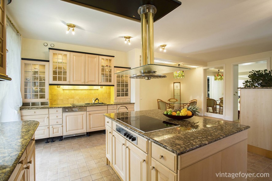 If you’re looking for something cheerful, try a burst of yellow, along with cream-colored cabinets and flooring. 