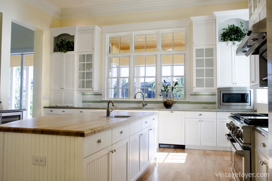 Details make all the difference. This kitchen infuses cottage-style living with modernity by using paneling on the white cabinets and choosing glass doors for the cabinets to enhance the natural light.