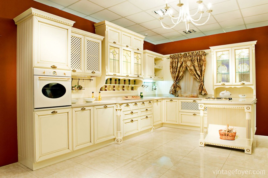 The highlight of this kitchen is the unique latticework on the cabinets and the contrast between the white of the cabinets with the red of the walls.