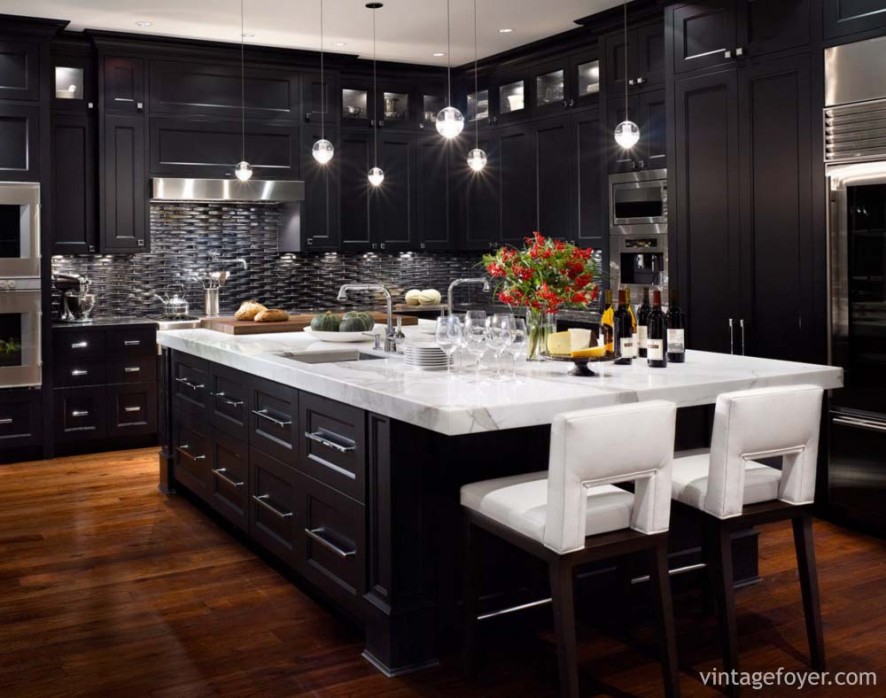 Dark tones in this kitchen with contrasting “pops” of white and high end appliances offer a modern twist to this traditional kitchen. 