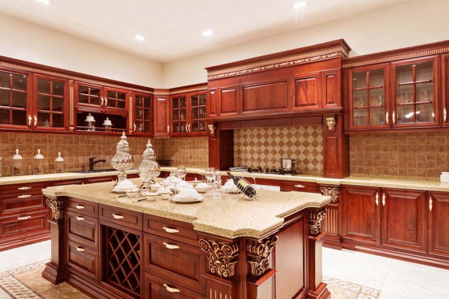 Elegant cherry cabinetry with grand wood carvings