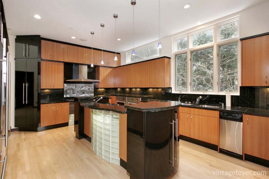 Kitchen in luxury home with wood paneling and marble island