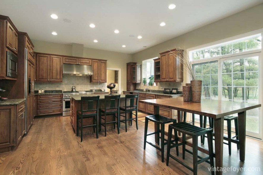 Luxury kitchen with wood cabinets and eating area