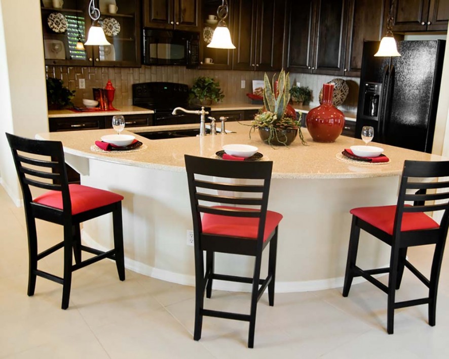 Beautiful large modern kitchen island area in new home with bar stools